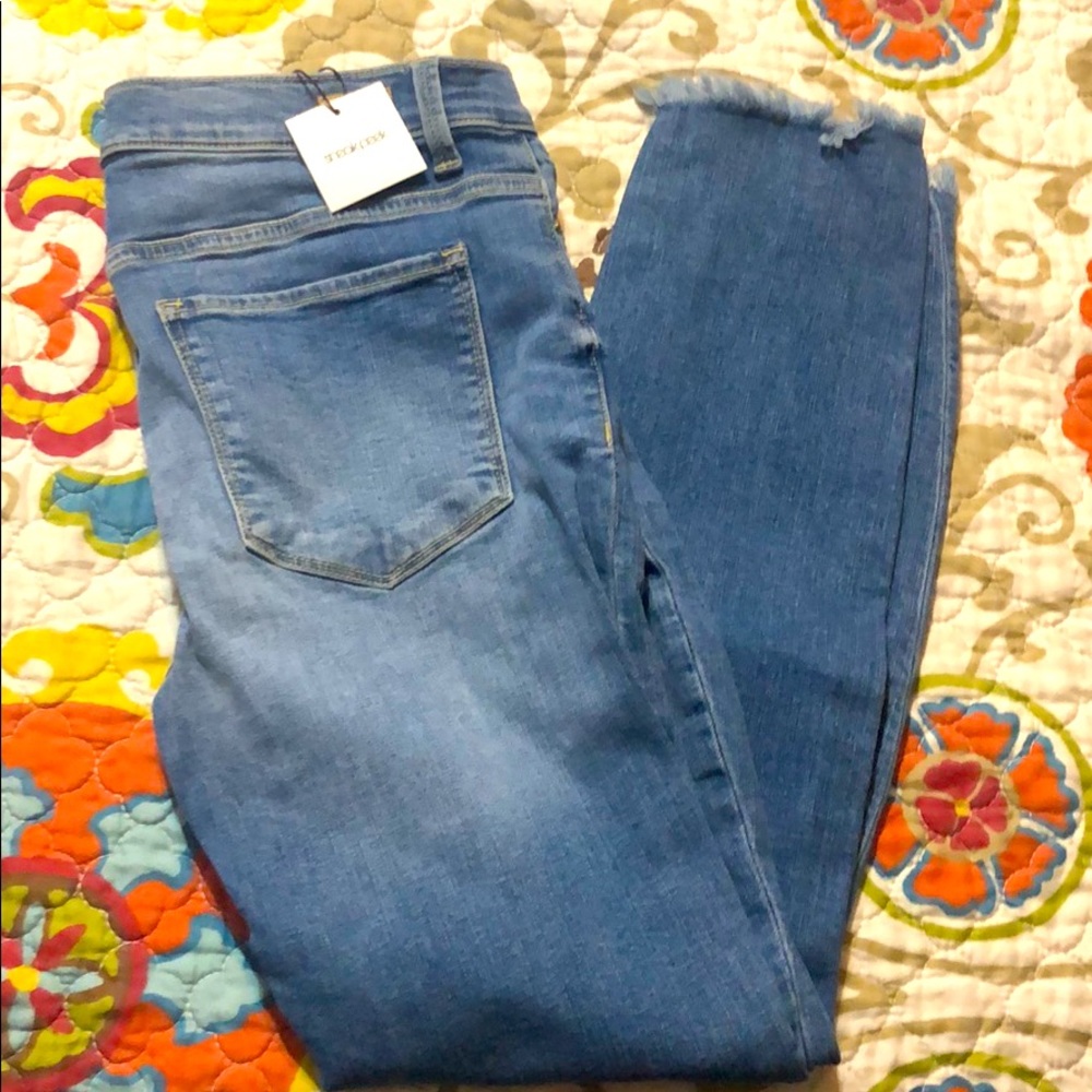 Sneak peek jeans with frayed bottom. NWT